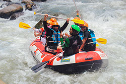 A group of tourists enjoying water rafting on river nile in Africa